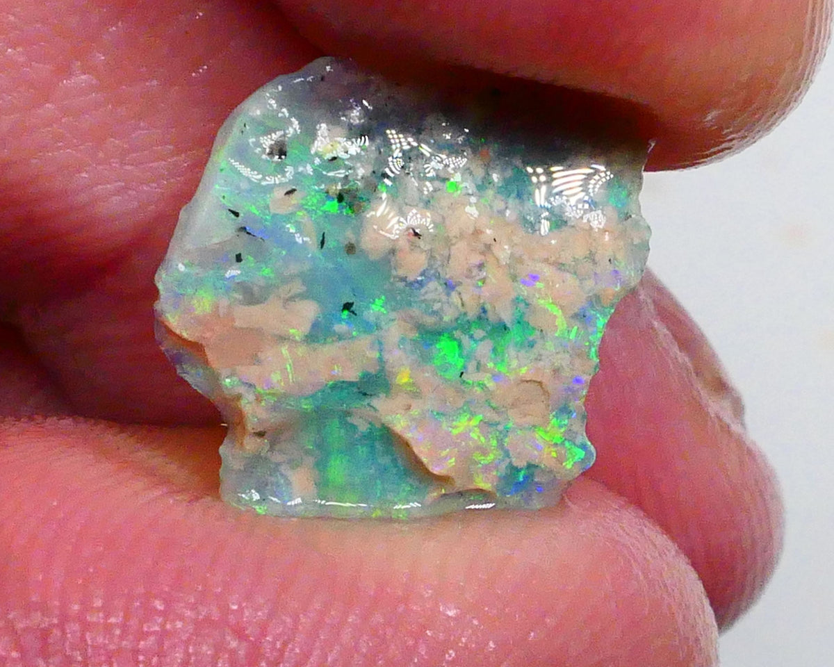 Thin profile knobby opal rough 2.50cts Dark base with Yellow/Green/Blue fires inclusions to work around 13x12x3mm Lot B4-A469