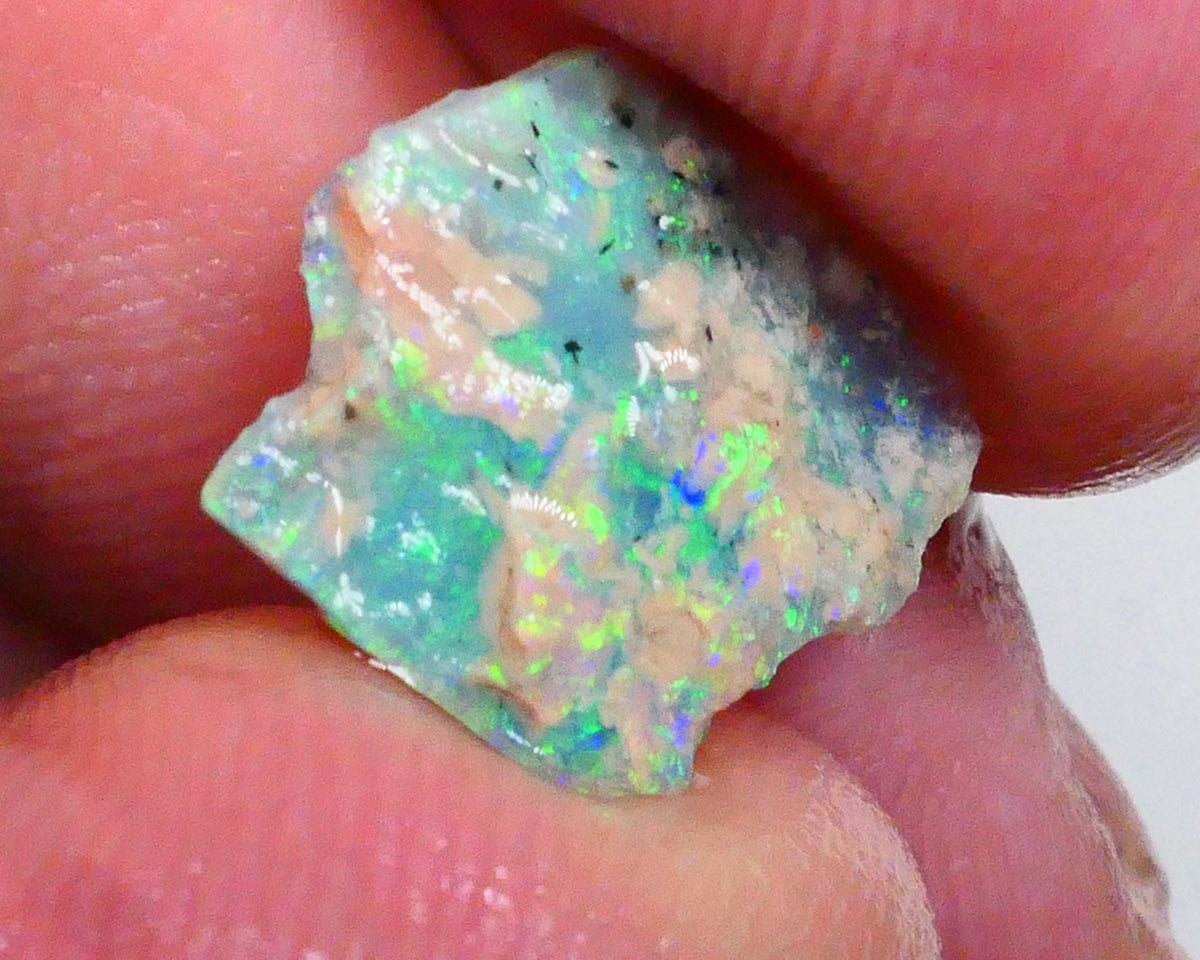 Thin profile knobby opal rough 2.50cts Dark base with Yellow/Green/Blue fires inclusions to work around 13x12x3mm Lot B4-A469