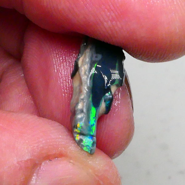 Green/Yellows/Blues on Black/Dark base seam opal rough 4.20cts Bright Bar thin visible all around 19x7x6mm Lot B4-A477