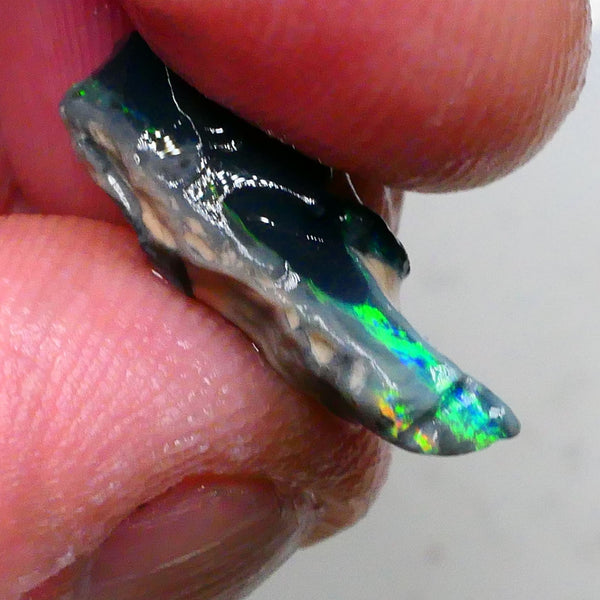 Green/Yellows/Blues on Black/Dark base seam opal rough 4.20cts Bright Bar thin visible all around 19x7x6mm Lot B4-A477