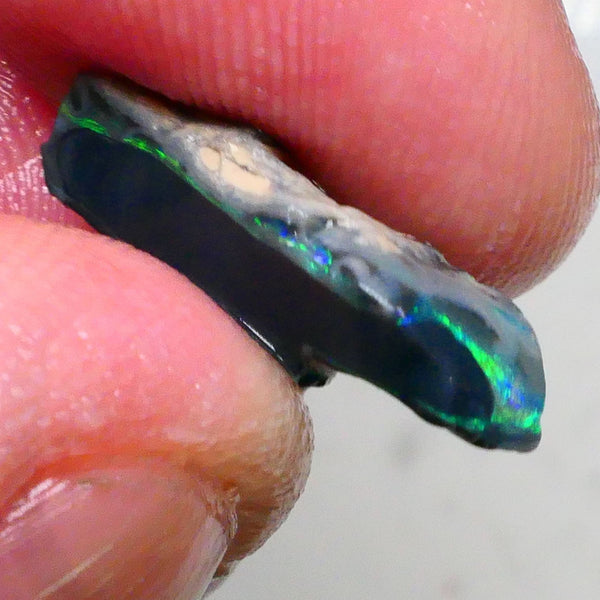 Green/Yellows/Blues on Black/Dark base seam opal rough 4.20cts Bright Bar thin visible all around 19x7x6mm Lot B4-A477