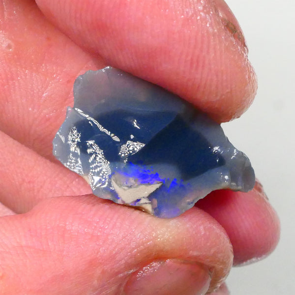 Piece of a Dark base knobby opal rough 12.35cts Lightning Ridge Zone of exposed Blue fires to gamble 23x14x10mm Lot B4-A745
