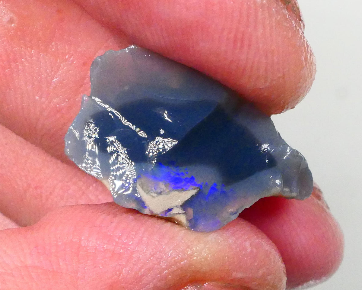 Piece of a Dark base knobby opal rough 12.35cts Lightning Ridge Zone of exposed Blue fires to gamble 23x14x10mm Lot B4-A745