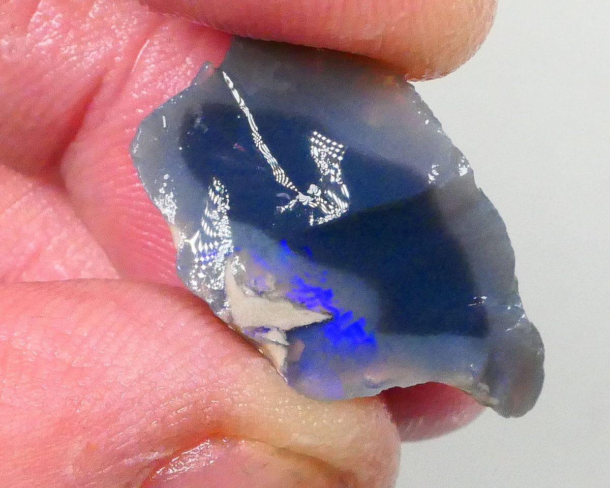 Piece of a Dark base knobby opal rough 12.35cts Lightning Ridge Zone of exposed Blue fires to gamble 23x14x10mm Lot B4-A745