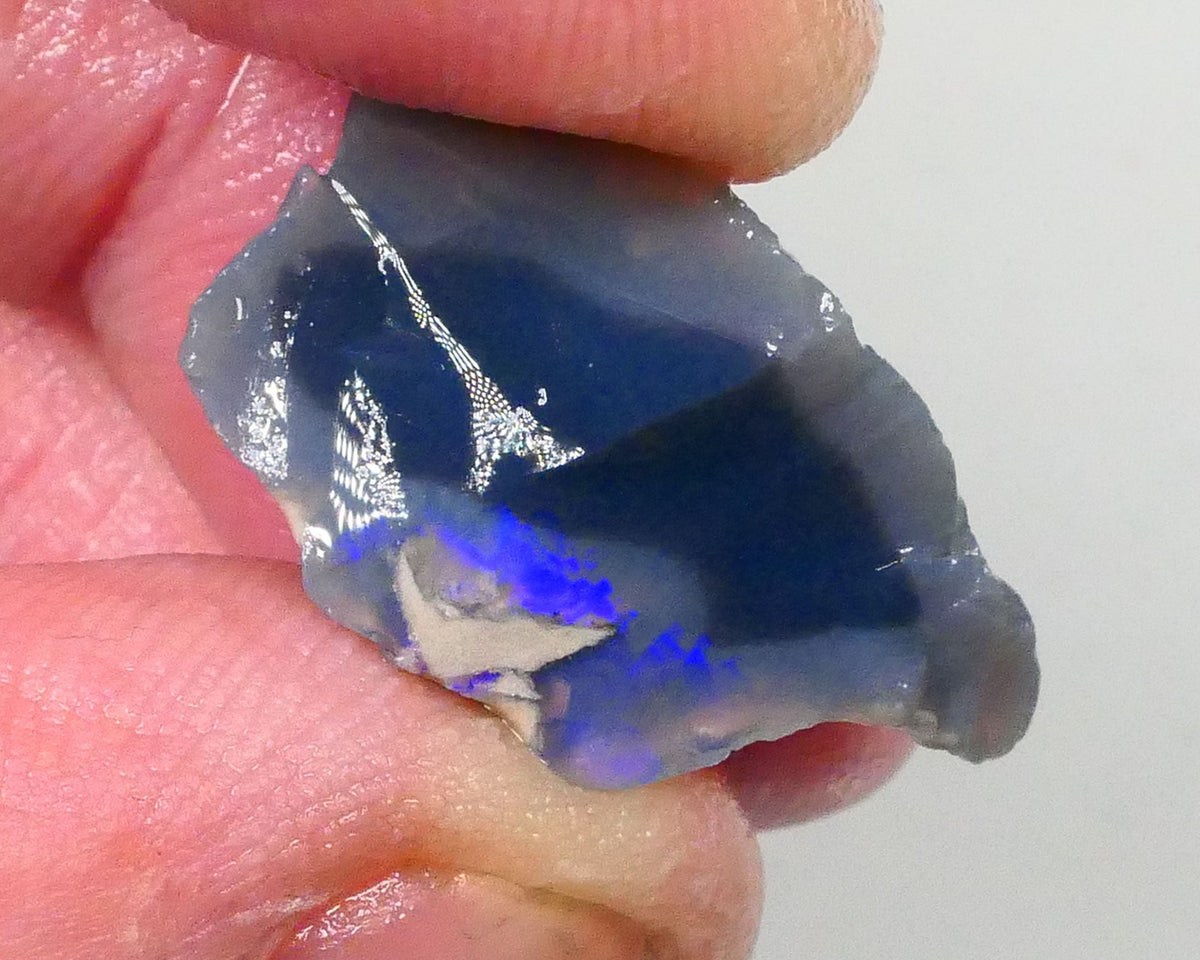 Piece of a Dark base knobby opal rough 12.35cts Lightning Ridge Zone of exposed Blue fires to gamble 23x14x10mm Lot B4-A745